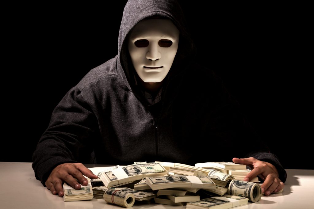 Hacker in a hood on dark background
