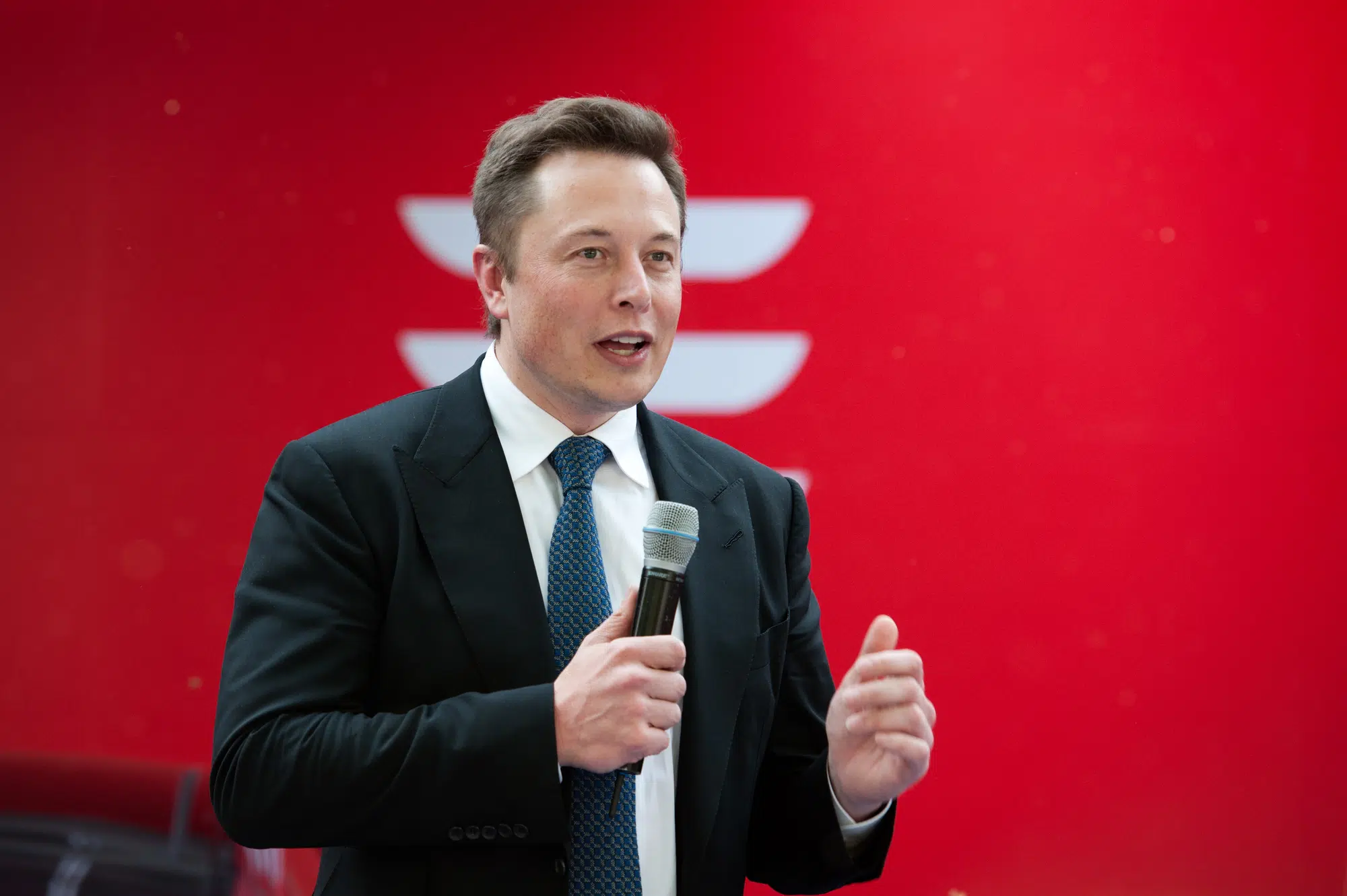 Tesla CEO Elon Musk speaks during a delivery ceremony for the first Model S electric cars in China in Beijing, China, 22 April 2014. Tesla Motors Inc. delivered its first eight electric cars to customers in China on Tuesday (22 April 2014) and CEO Elon Musk said the company will build a nationwide network of charging stations and service centers as fast as it can. Tesla probably will invest several hundred million dollars in charging infrastructure in China, Musk told reporters. He said it will open several hundred service centers. Customers received the first Model S sedans at a brief ceremony at Teslas office in a Beijing industrial park, also the site of its first Chinese charging station.