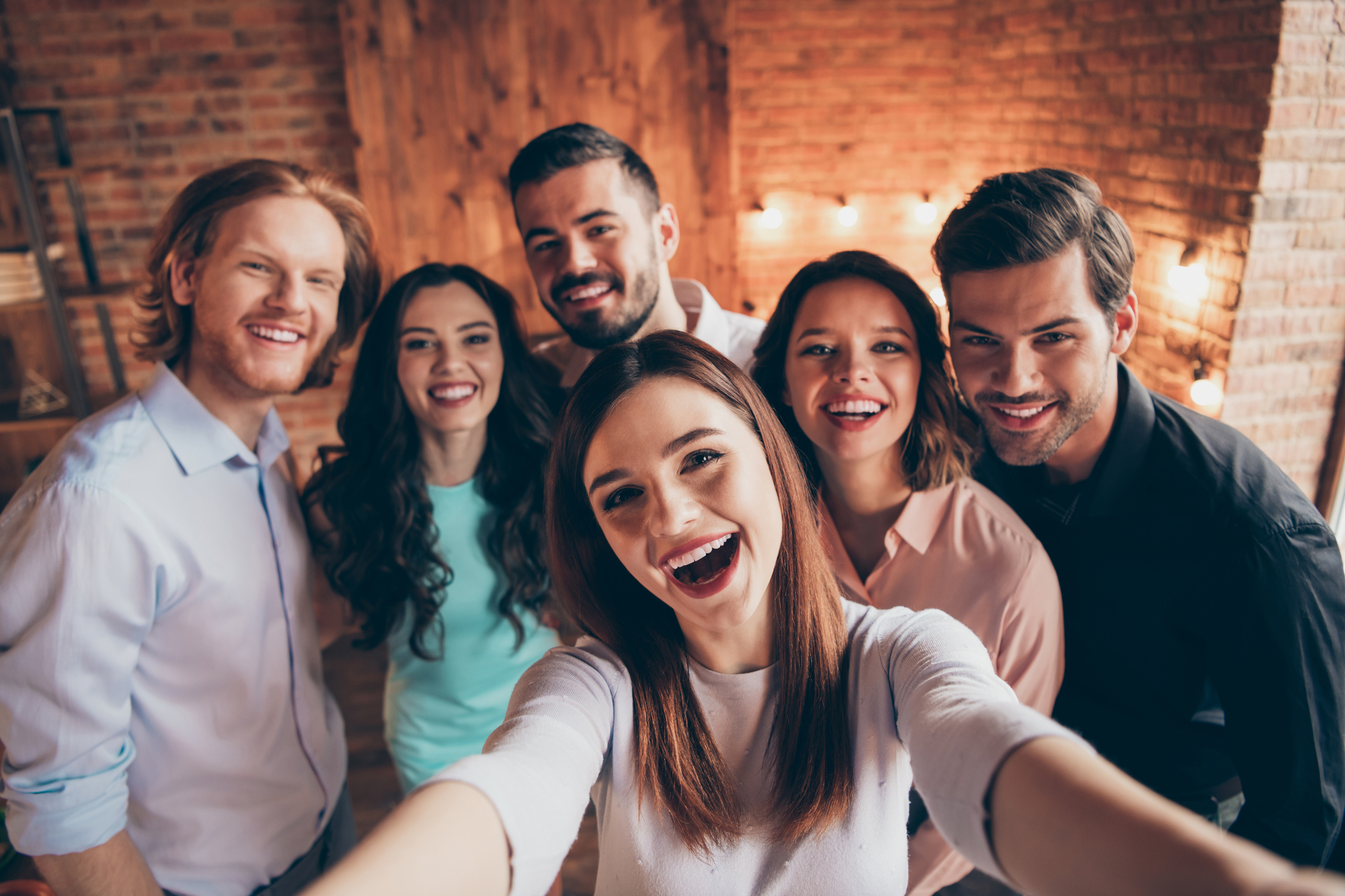 Self-portrait of nice attractive lovely charming winsome cheerful cheery glad ecstatic positive ladies gentlemen having fun embracing house event dream in industrial loft interior room indoors.