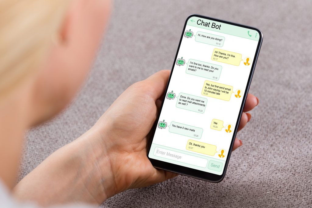 Close-up Of Woman Using Chat Bot Application For Chatting On Smartphone