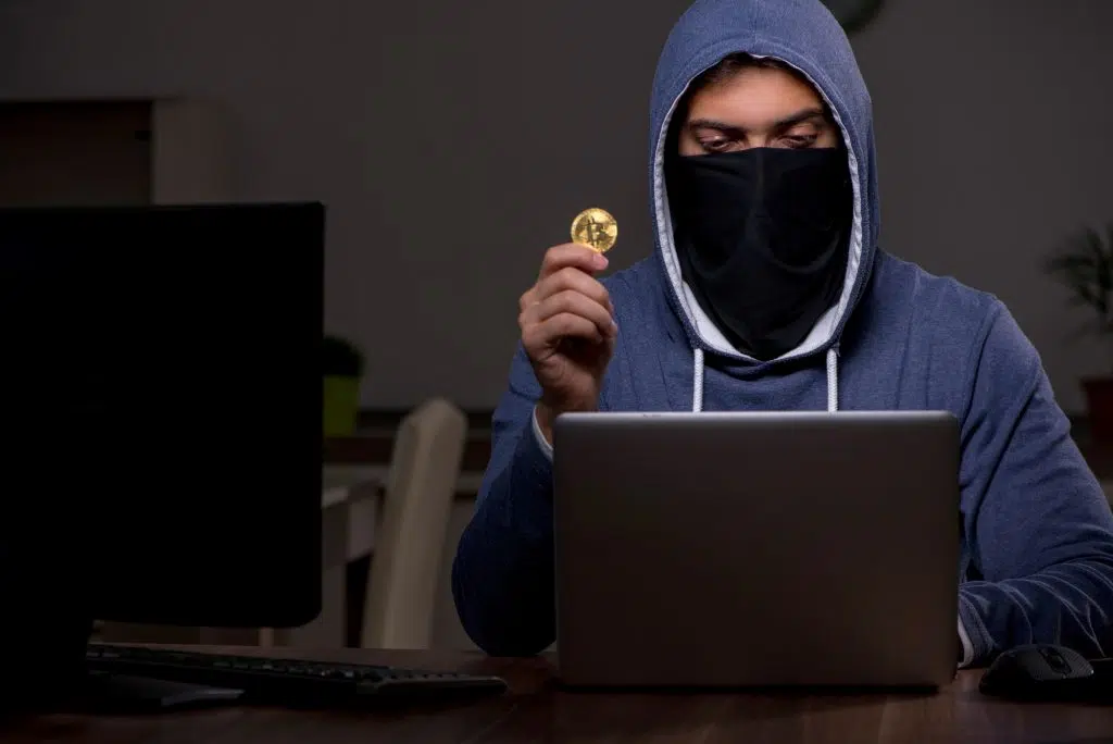 Male hacker hacking security firewall late in the office