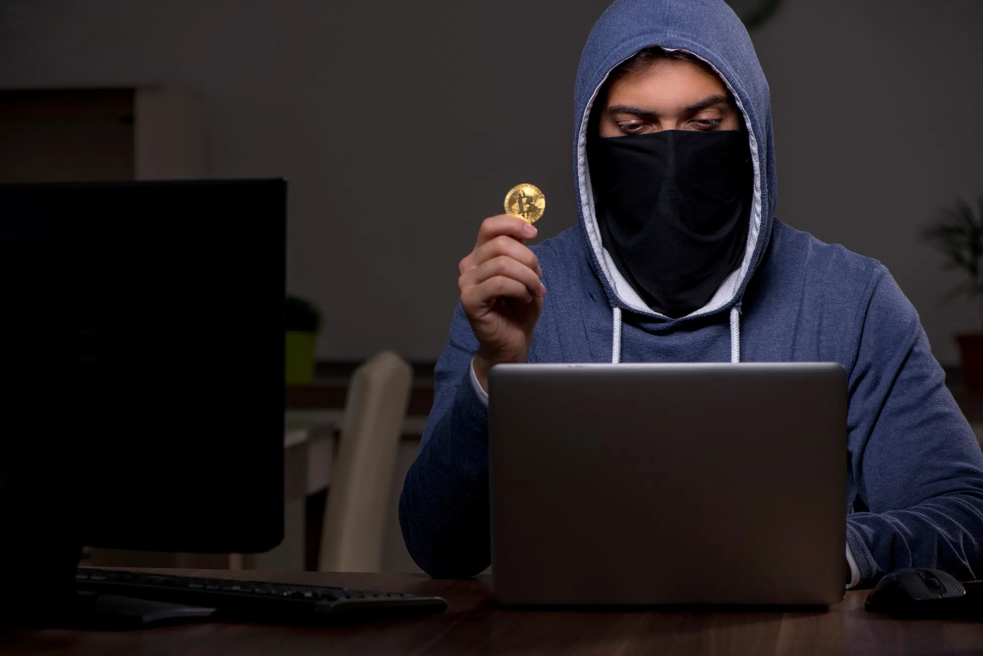 Male hacker hacking security firewall late in the office