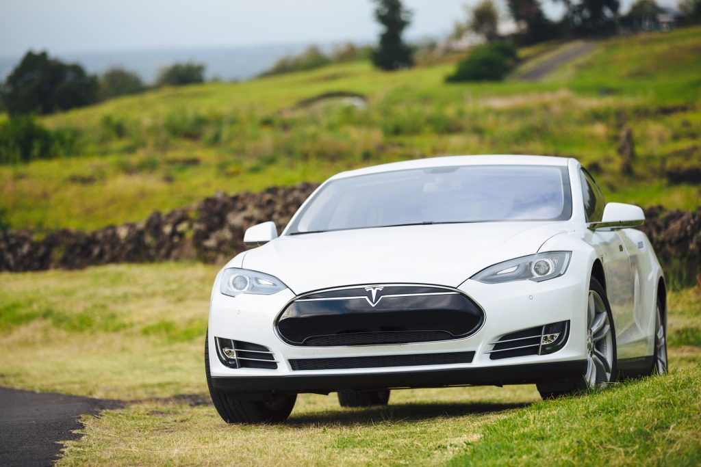 San Francisco, CA - April 2014: Tesla Motors model S sedan electric car on country road, Tesla's new Gigafactory would help Tesla increase its monthly production volume to 20,000 cars per month.