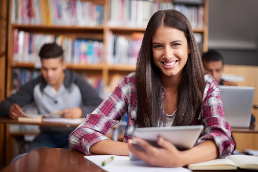 University, tablet and portrait of woman in class for online research, studying and learning. Education, school and library for happy female student on digital tech for knowledge, internet or website