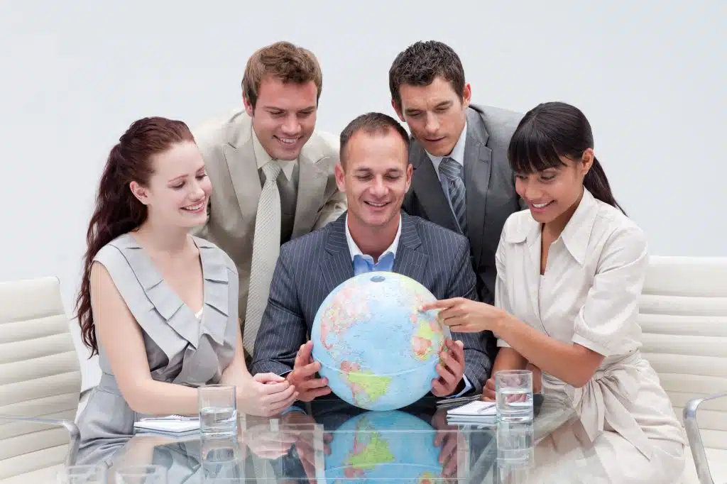 Business team holding a terrestrial globe in the office