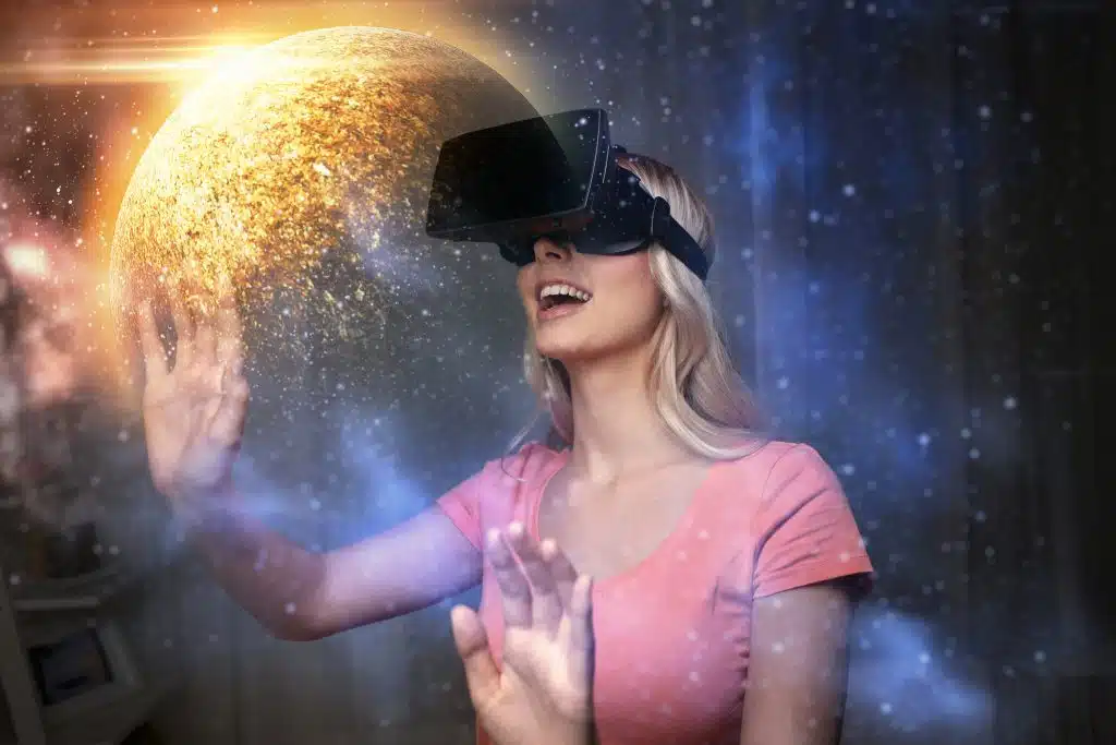 technology, augmented reality and people concept - happy young woman with virtual headset or 3d glasses over planet and space background