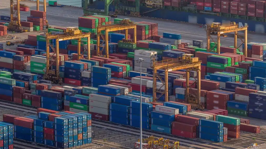 Commercial port of Singapore aerial timelapse. Bird eye close up view to loaders of busiest Asian cargo port with hundreds of ships loading export and import goods and thousands of containers in harbor