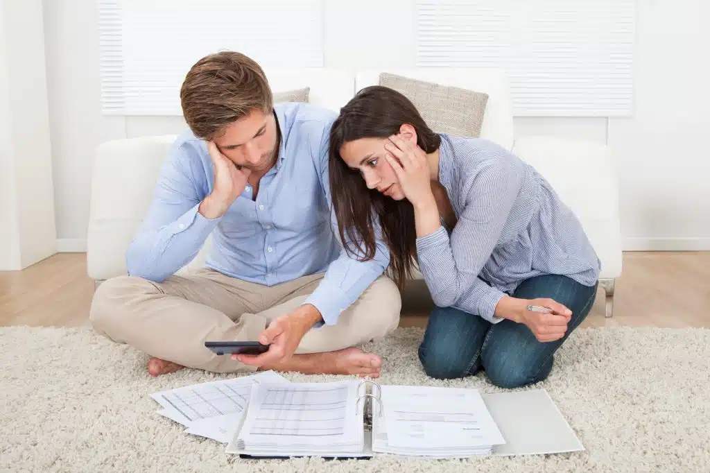 Unhappy young couple in financial trouble at home