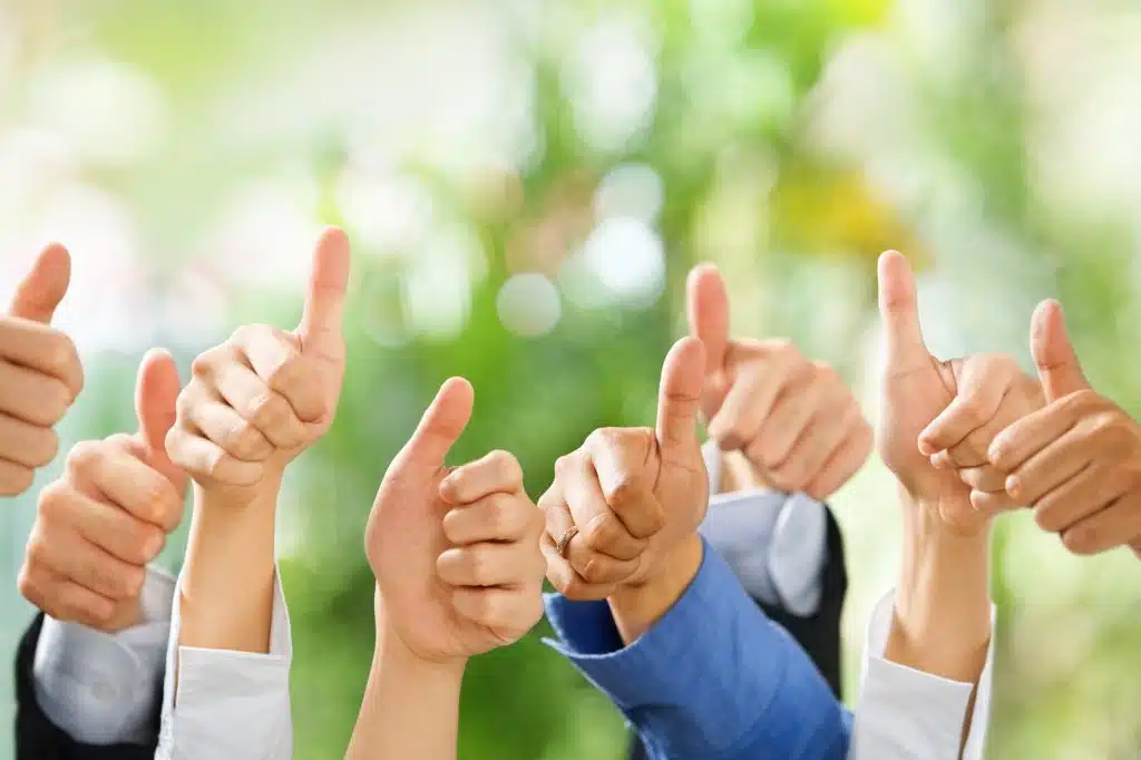 Thumbs up from diverse group of people on green background