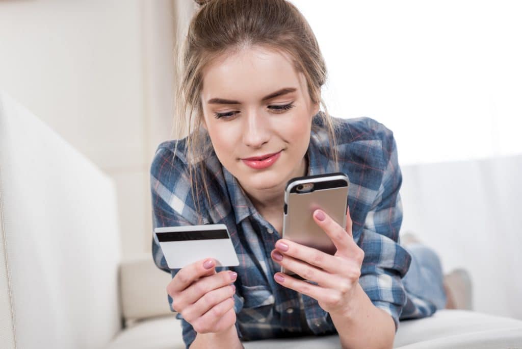 A woman is going to pay with a credit card on the Internet