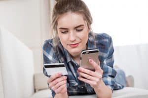 A woman is going to pay with a credit card on the Internet