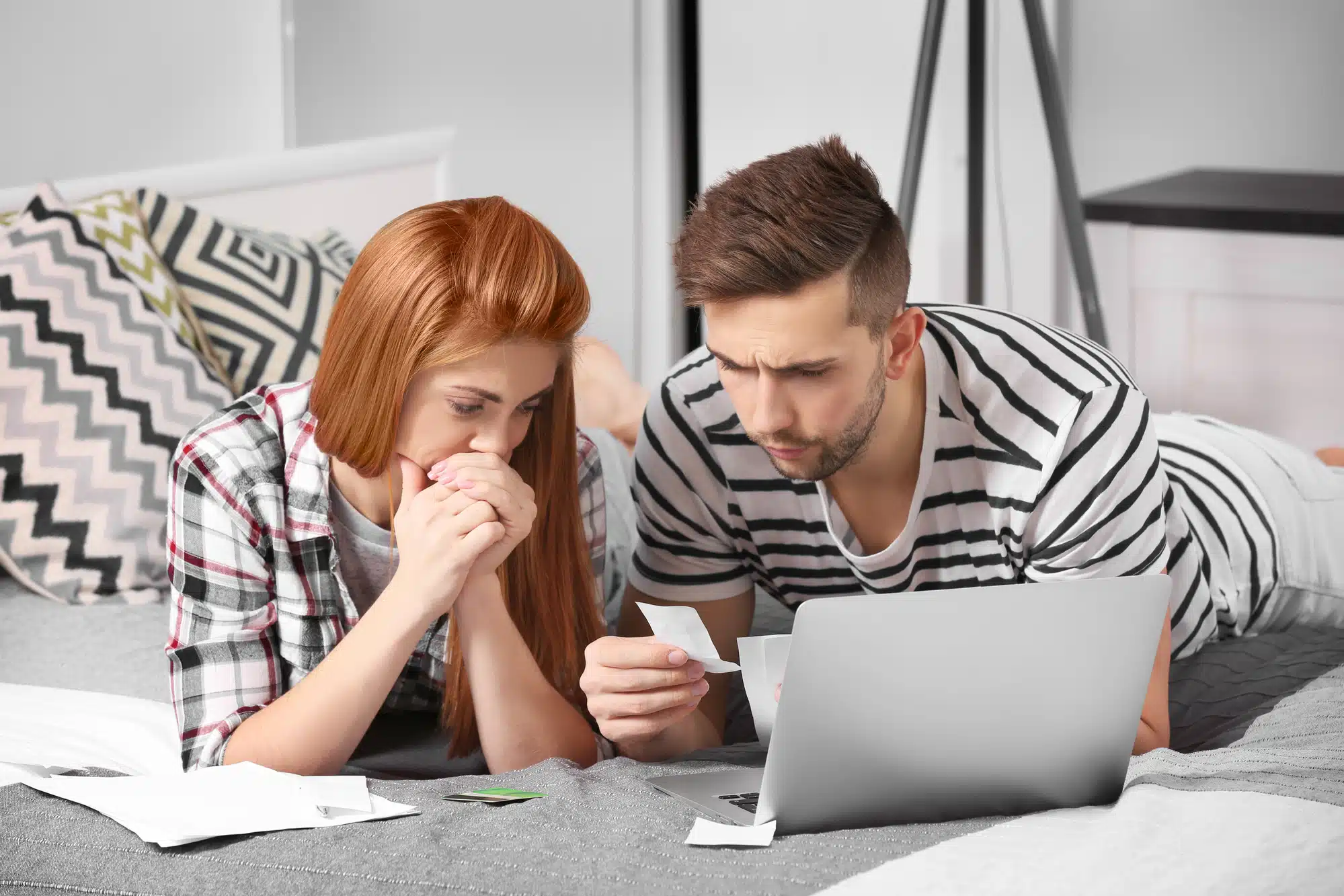 Young couple calculating taxes at home