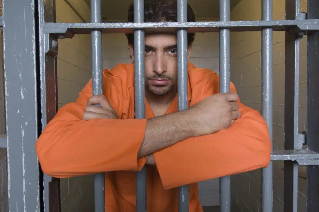 Portrait of prisoner behind bars