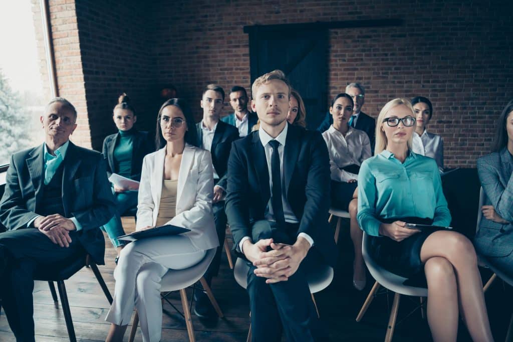 Nice stylish elegant confident top managers sharks sitting on chairs listening to ceo boss chief startup finance invest project corporate at industrial loft interior room work place space indoors.