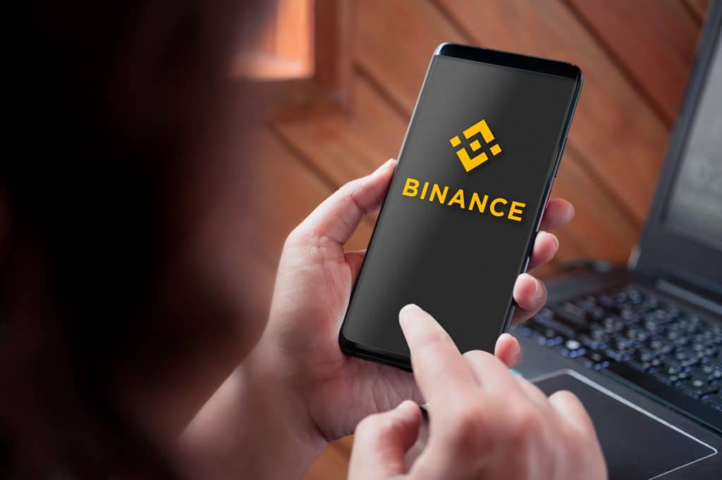 Bangkok, Thailand - Septempber 3, 2019: Hand holding smartphone with Binance logo on screen. Binance is a global cryptocurrency exchange that provides a platform for trading more than 100 cryptocurrencies.