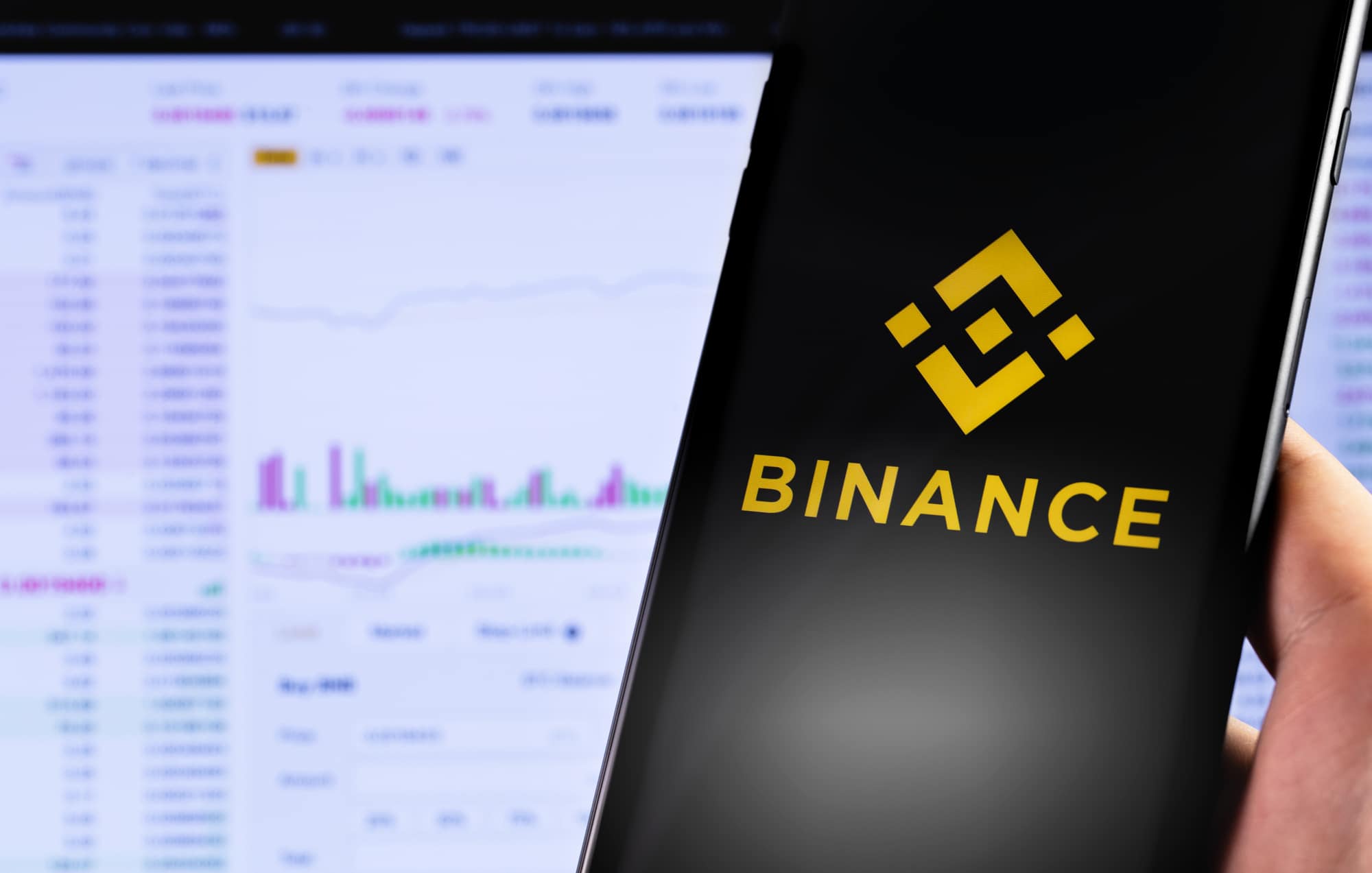 Binance logo on the screen smartphone and display notebook closeup. Binance - one of the largest cryptocurrency exchange on the market. Moscow, Russia - May 20, 2019