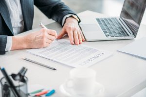 A man signs a contract with an employer