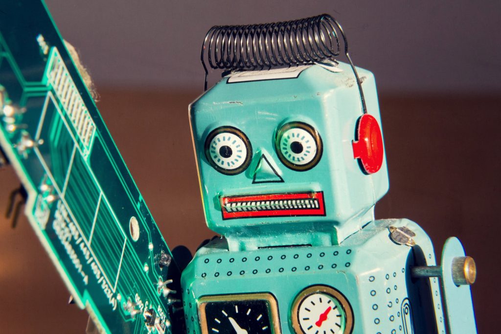 Tin toy robot carries computer circuit board, artificial intelligence concept