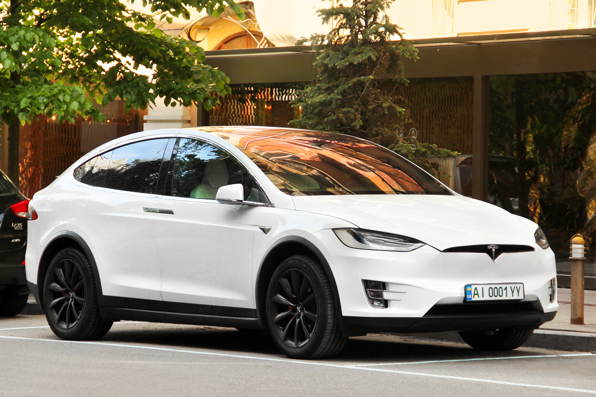 Kiev, Ukraine - May 22, 2021: Tesla Model X white electric car parked in the city
