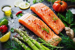Fresh salmon fillet with aromatic herbs, spices and vegetables. Balanced diet or cooking concept