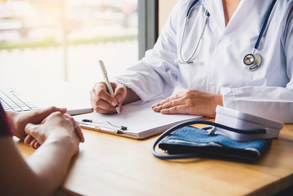 The doctor is discussing with the patient after a physical examination of the results and treatment guidelines.