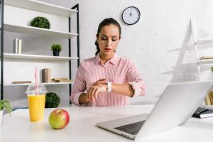 woman looking at smart watch