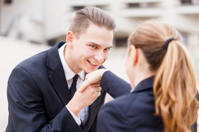 Young businessman greet polite his partner with kissing hand