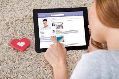 Rear View Of Woman Chatting On Social Networking Sites Using Laptop
