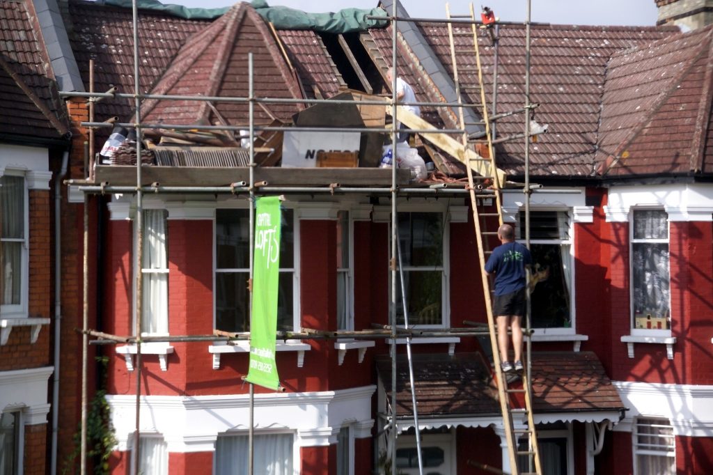 builders building loft extension in suburban house