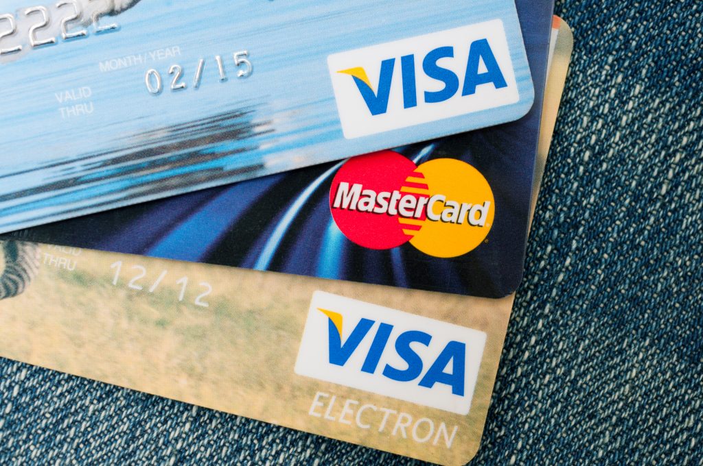 PRAGUE, CZECH REPUBLIC – DECEMBER 27, 2013: Photo of VISA and MasterCard credit cards on blue jeans