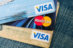 PRAGUE, CZECH REPUBLIC – DECEMBER 27, 2013: Photo of VISA and MasterCard credit cards on blue jeans