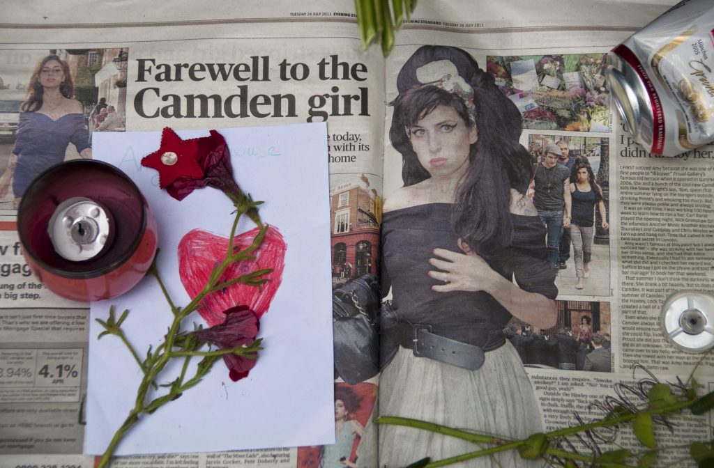 Фани вшановують пам'ять Емі Вайнхаус перед її будинком на площі Камден, 27 липня 2011 року в Лондоні