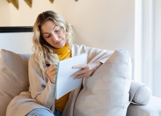 жінка записує у блокнот