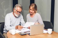 пенсіонери читають документи